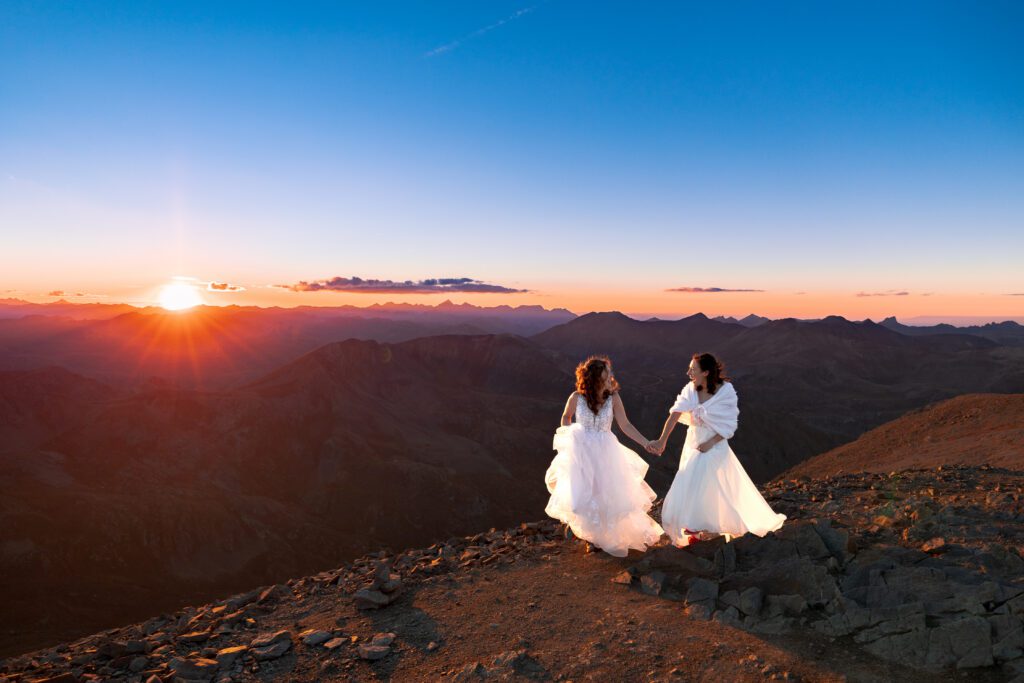 Two brides getting married at the top of Handies Peak in Colorado at sunset
