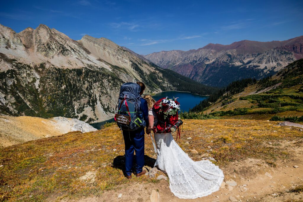 Newlyweds with their backpacking attire on after summiting Trailrider Pass near Aspen colorado