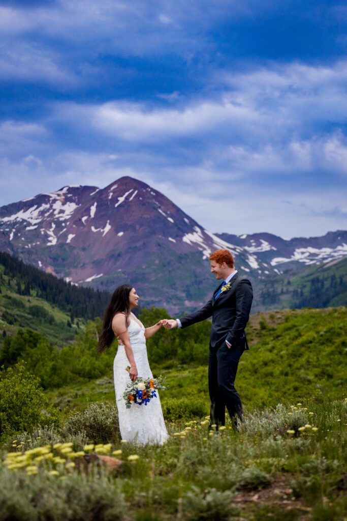 A newly wed couple in a field of wildflowers late June near Crested Butte Colorado