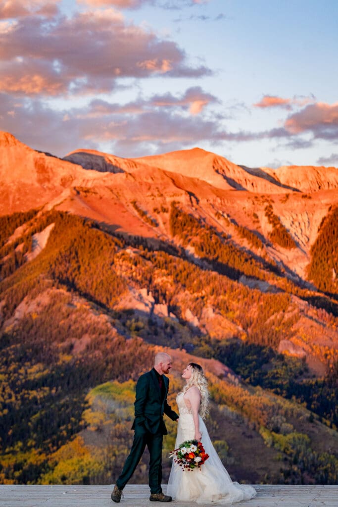 A bride and groom about to kiss at San Sofia overlook in Telluride Colorado at sunset
